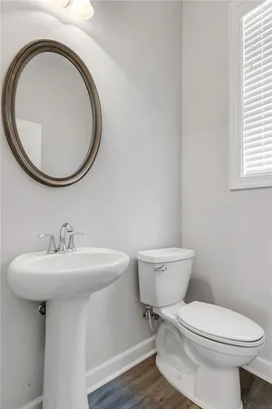a bathroom with a sink a toilet and a mirror
