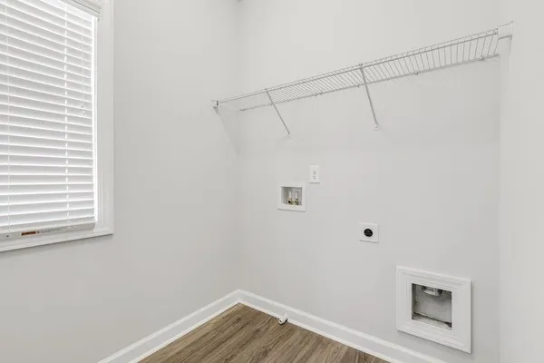 a view of a small space with wooden floor and a window