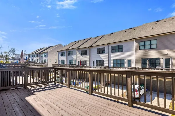 a view of a house with wooden deck