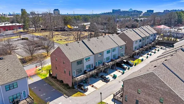 an aerial view of a house with a yard