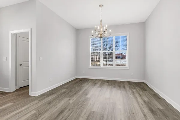 a view of livingroom with window wooden floor and chandelier