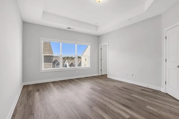 a view of room with wooden floor and window