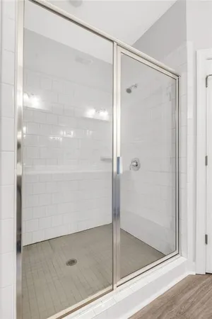 a bathroom with a glass shower door