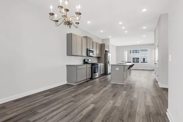 a view of kitchen with cabinets stainless steel appliances with wooden floor