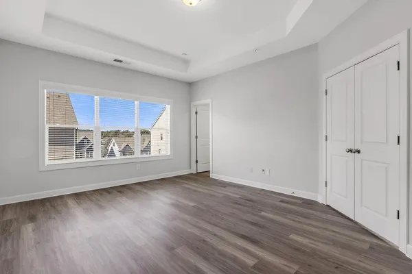 a view of room with wooden floor and window