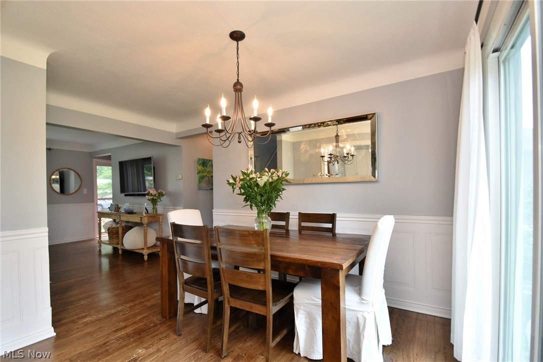 1174 Haverston Road Cleveland, OH 44124 - Photo 7 of 21 Dining area with dark wood-type flooring and a chandelier