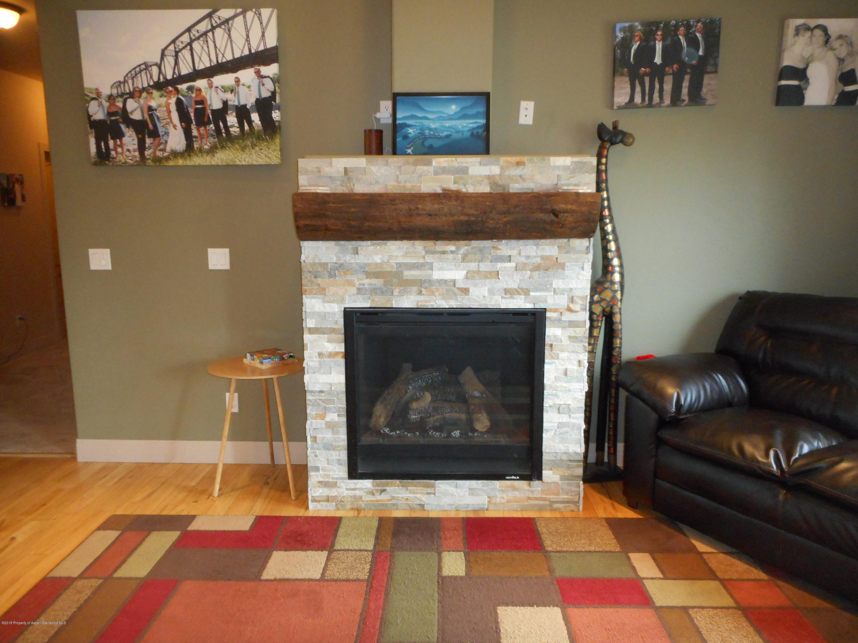 1851 Anvil View Avenue Rifle, CO 81650 - Photo 3 of 37 a living room with a fireplace and a rug