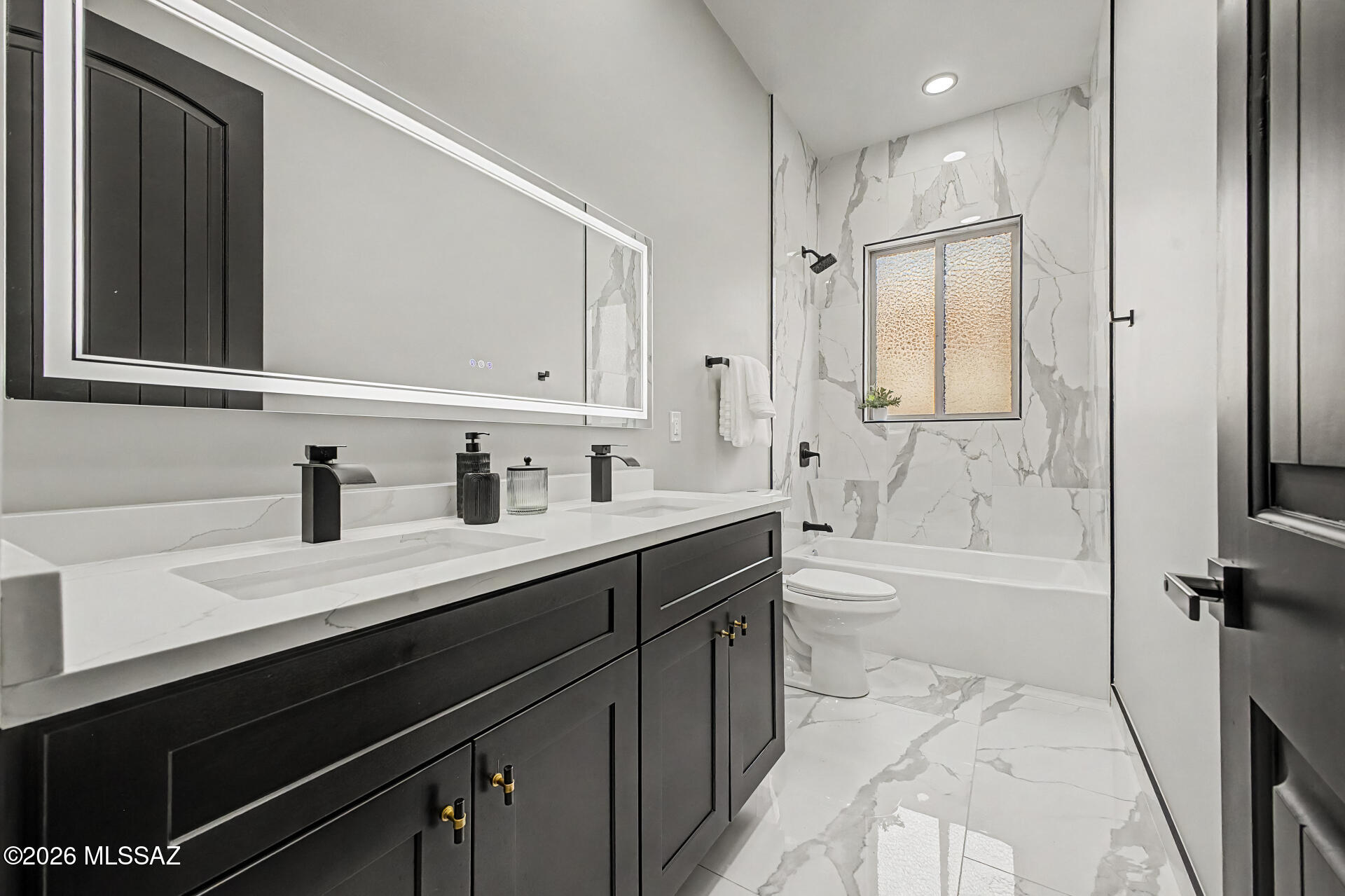 2399 Della Roccia Court Tucson, AZ 85737 - Photo 28 of 34 a bathroom with a bathtub shower sink vanity and toilet