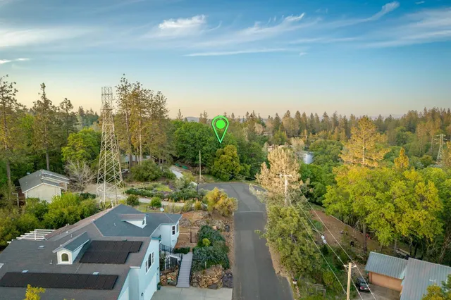 an aerial view of mountain with residential house and green space