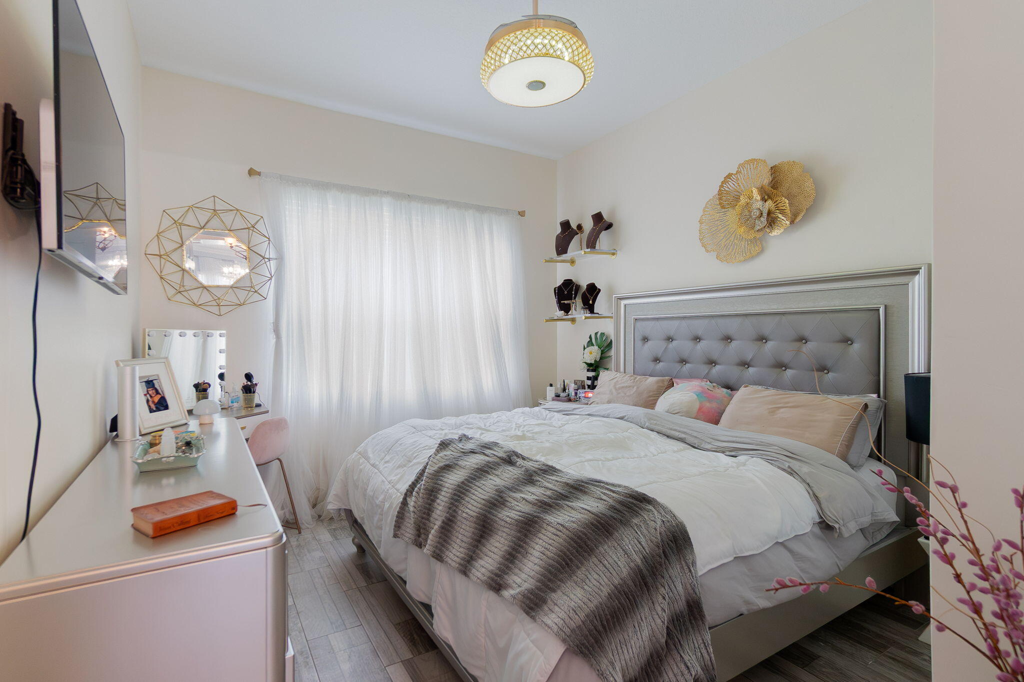 3011 Strada Court Royal Palm Beach, FL 33411 - Photo 14 of 57 a bedroom with a bed and a chandelier