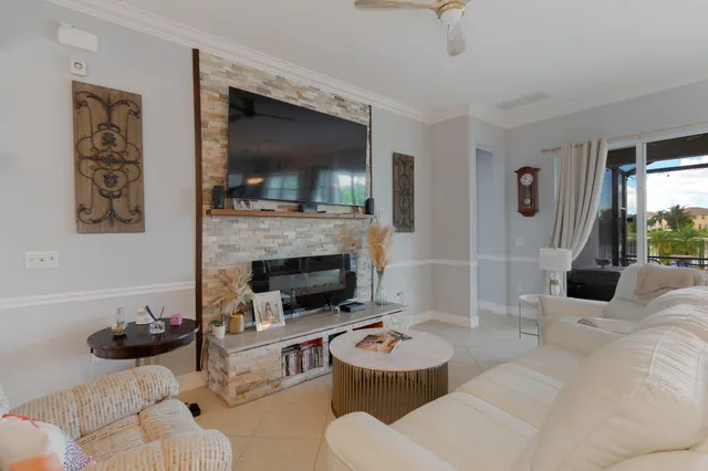 a living room with furniture and a view of kitchen