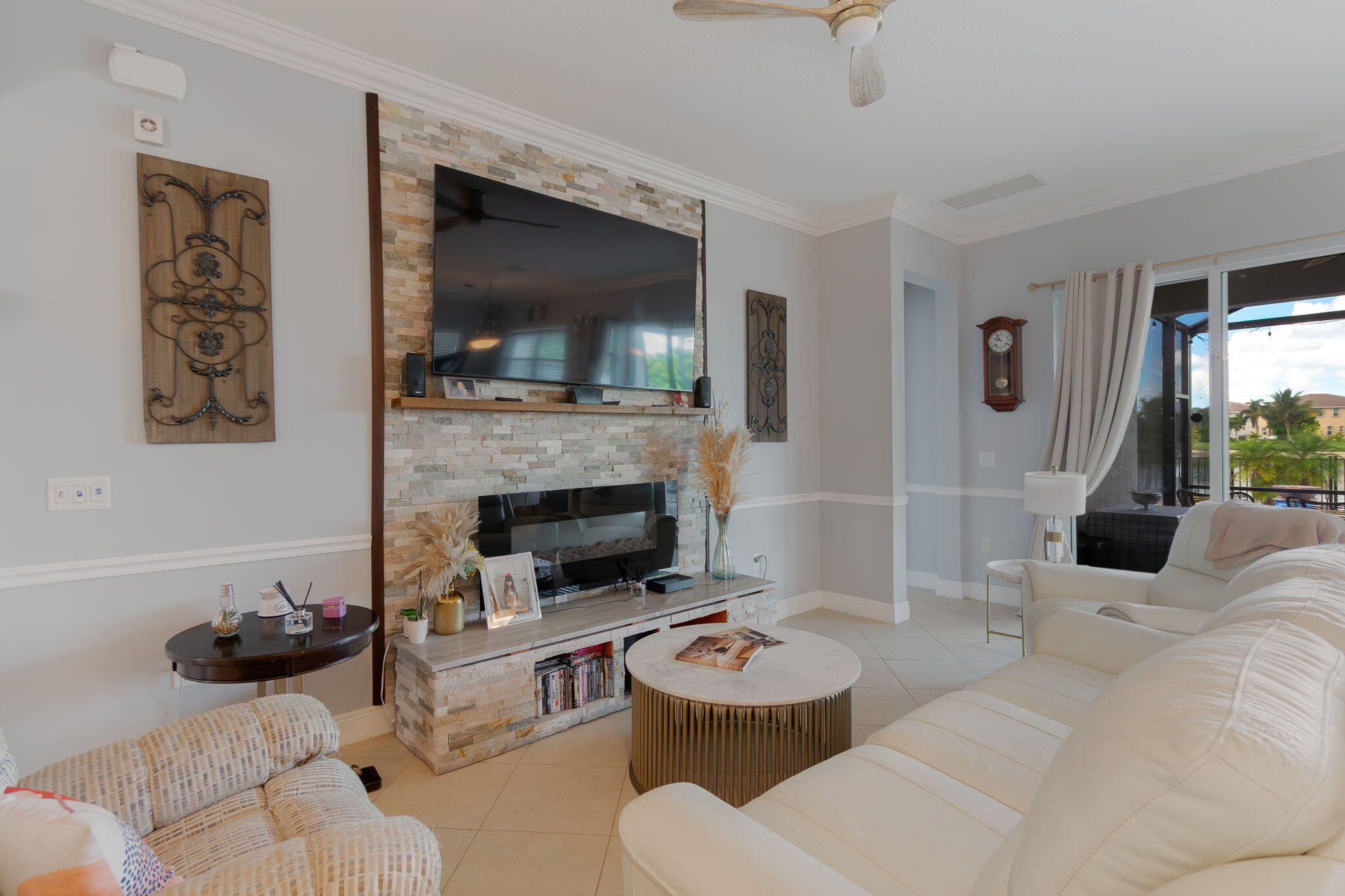 3011 Strada Court Royal Palm Beach, FL 33411 - Photo 15 of 57 a living room with furniture a flat screen tv and a fireplace