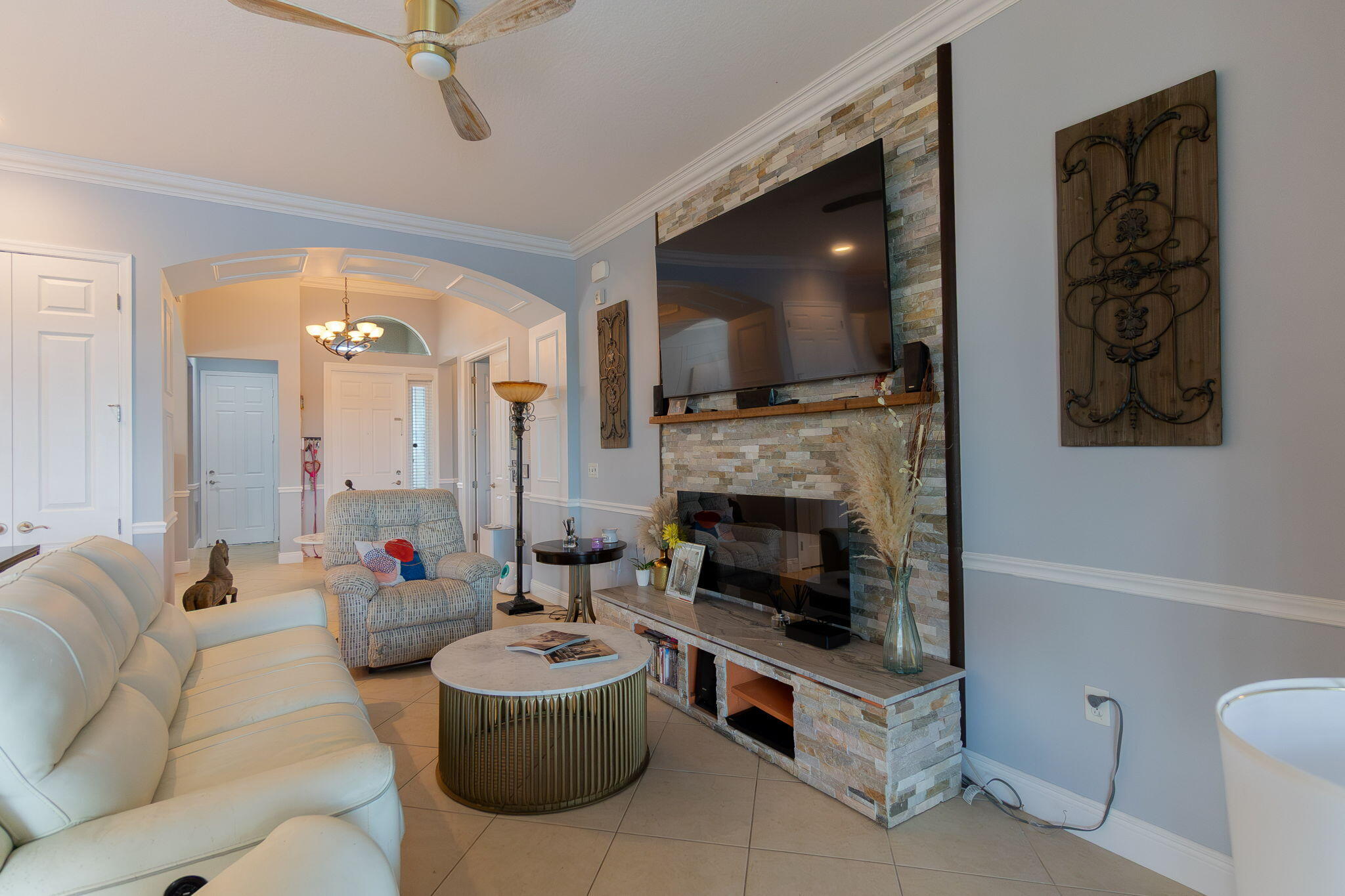 3011 Strada Court Royal Palm Beach, FL 33411 - Photo 16 of 57 a living room with furniture a flat screen tv and a fireplace