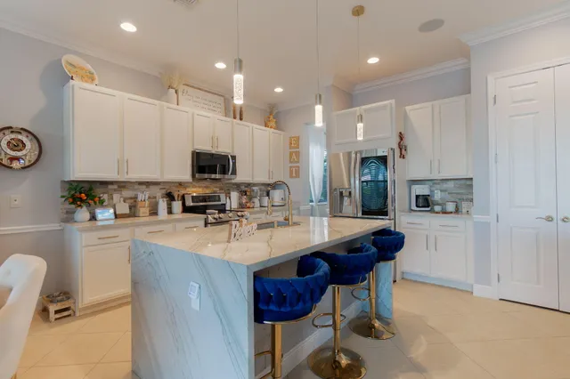 a kitchen with sink stove and refrigerator
