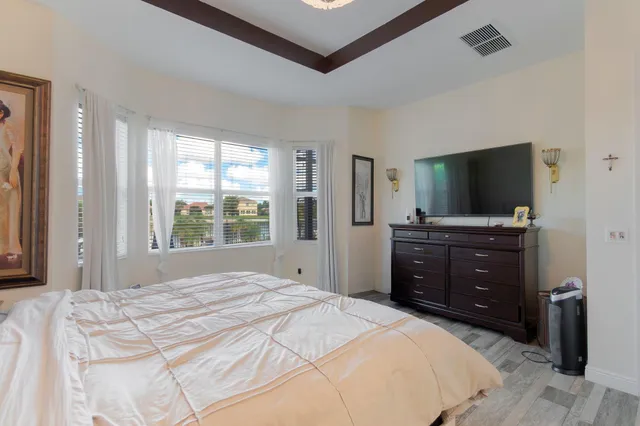 a bedroom with a bed lamp and a window