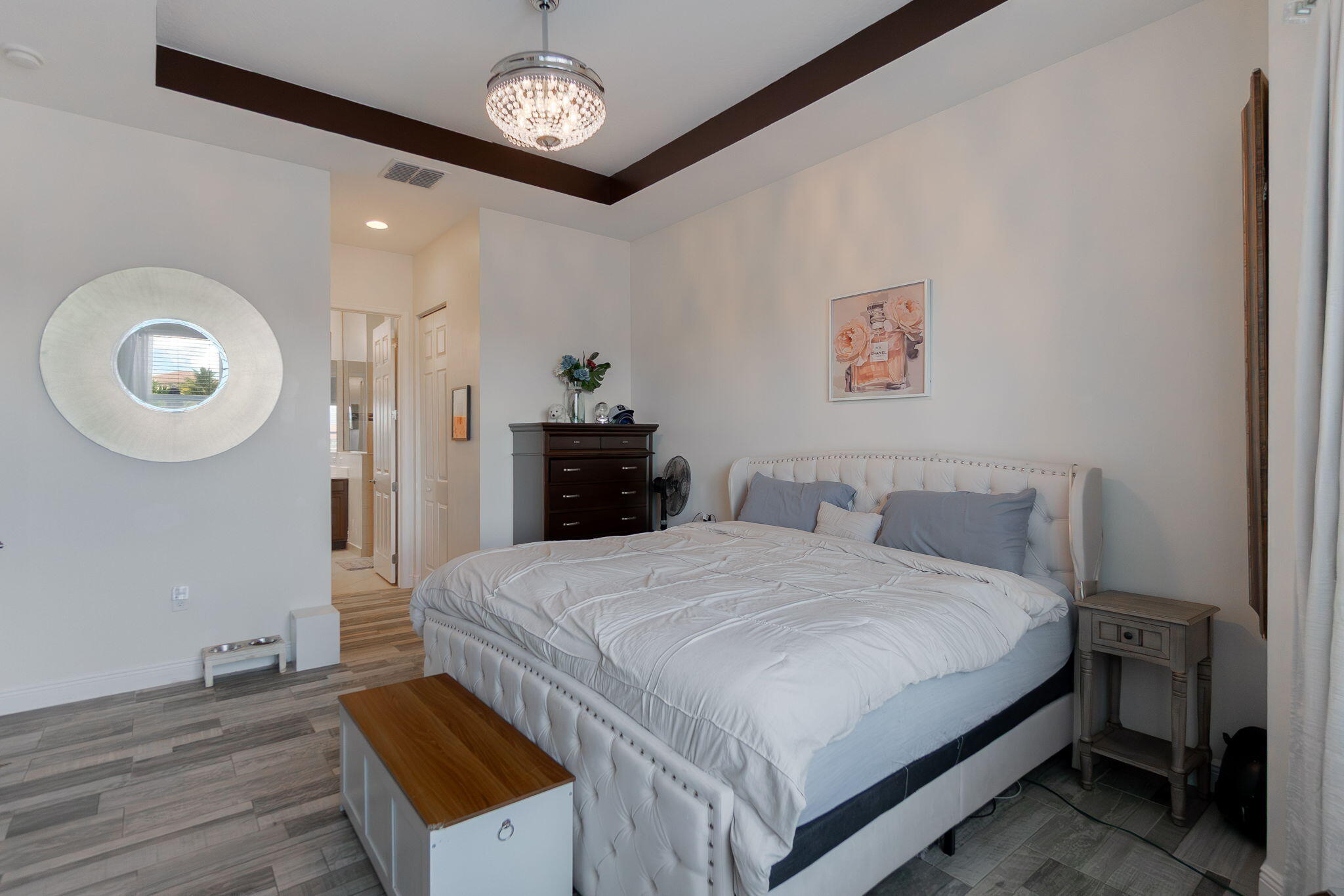 3011 Strada Court Royal Palm Beach, FL 33411 - Photo 23 of 57 a bedroom with a bed and a chandelier