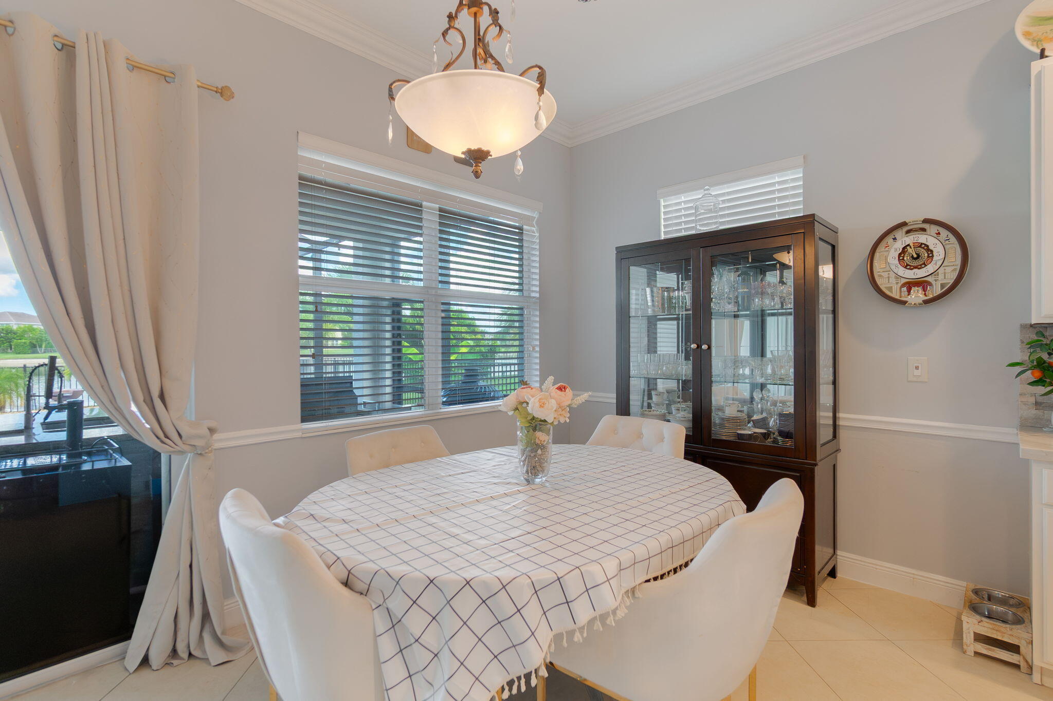 3011 Strada Court Royal Palm Beach, FL 33411 - Photo 27 of 57 a bedroom with a bed and a chandelier