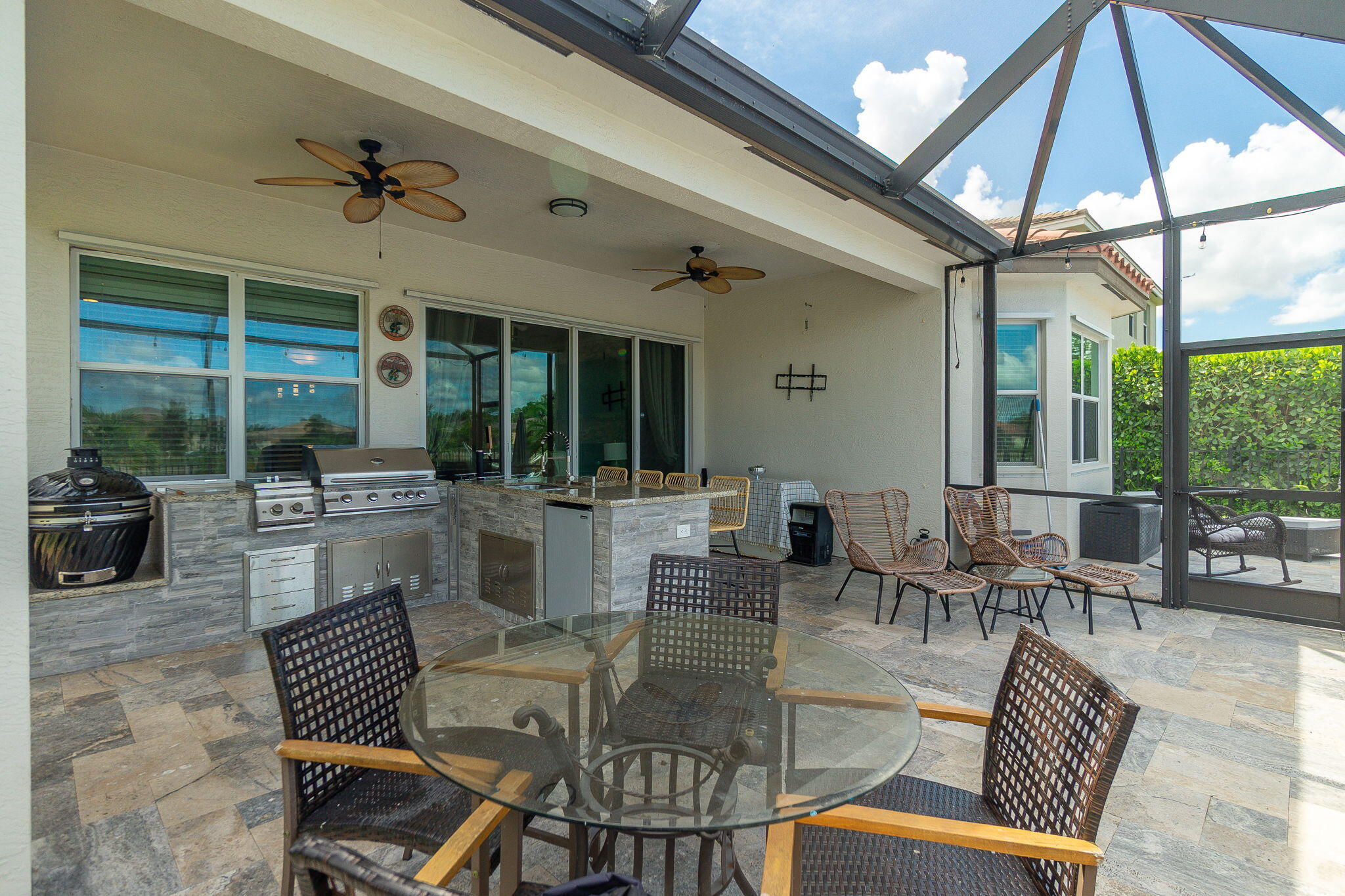 3011 Strada Court Royal Palm Beach, FL 33411 - Photo 31 of 57 a dining room with furniture a floor to ceiling window and potted plants