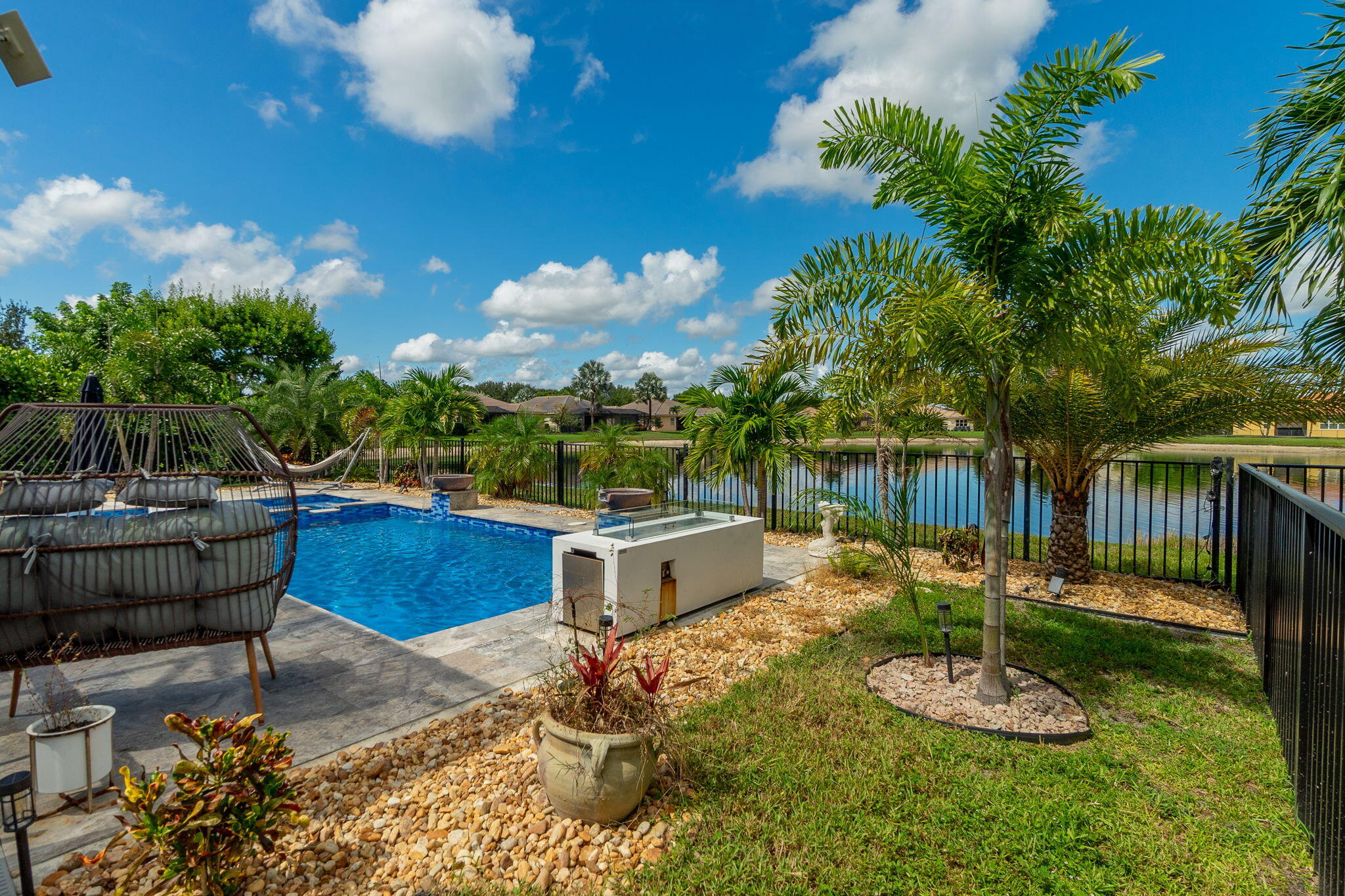 3011 Strada Court Royal Palm Beach, FL 33411 - Photo 36 of 57 a backyard of a house with yard and outdoor seating