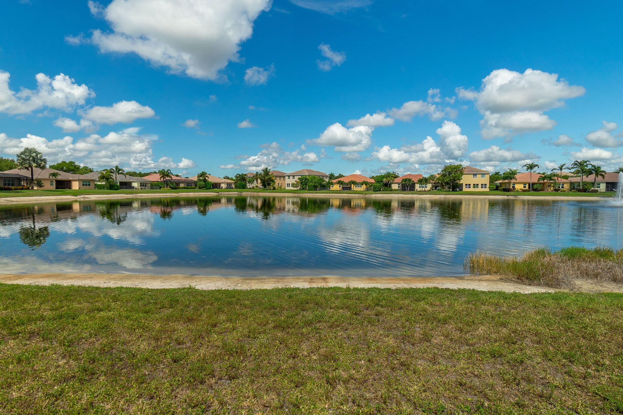 3011 Strada Court Royal Palm Beach, FL 33411 - Photo 38 of 57 a view of a lake with houses in the back