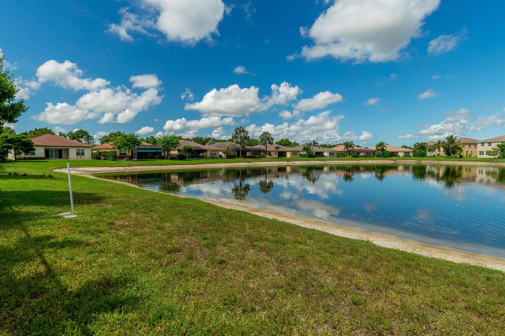 3011 Strada Court Royal Palm Beach, FL 33411 - Photo 39 of 57 a view of a lake with houses in the background