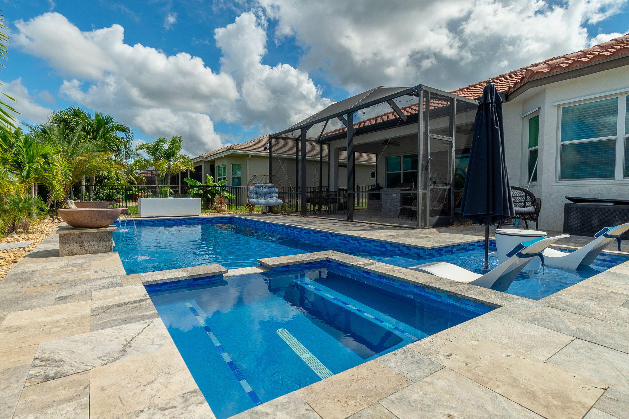 3011 Strada Court Royal Palm Beach, FL 33411 - Photo 49 of 57 a view of a patio with swimming pool table and chairs