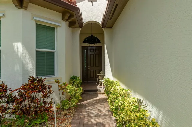 a house with a lot of flower plants