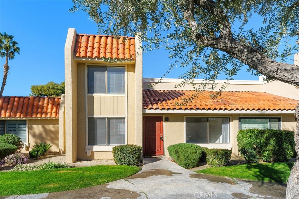 69707 Campana Court Rancho Mirage, CA 92270 - Photo 2 of 47 a front view of a house with garden and plants