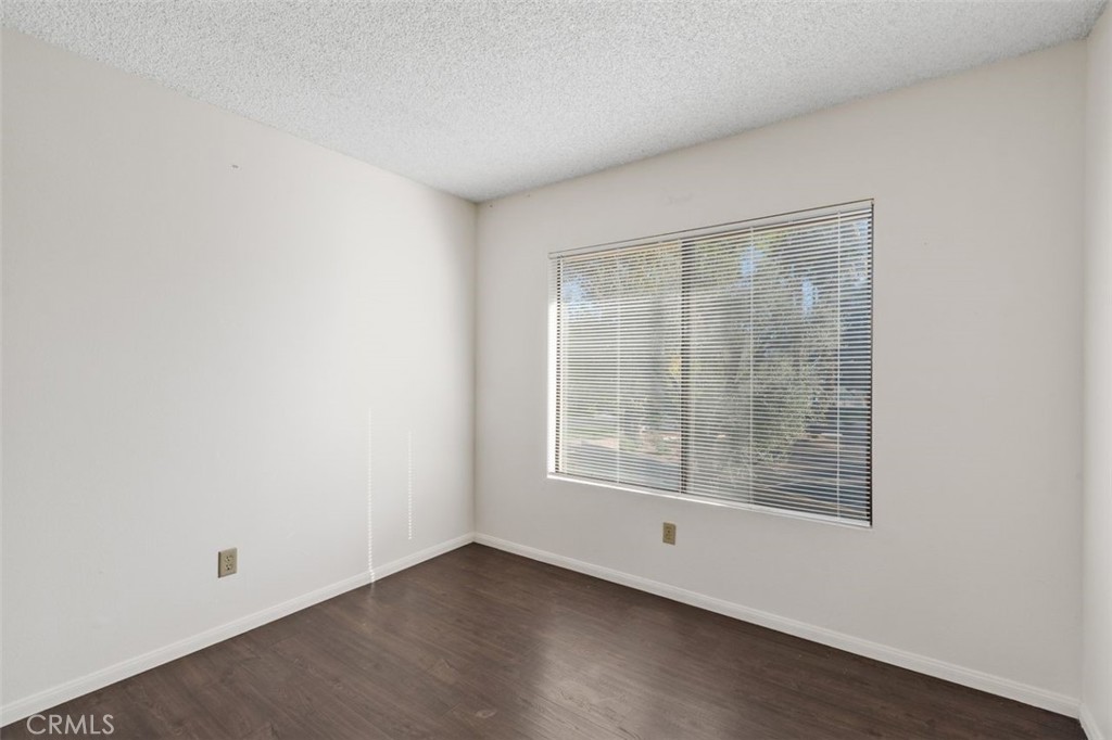69707 Campana Court Rancho Mirage, CA 92270 - Photo 24 of 47 an empty room with wooden floor and windows