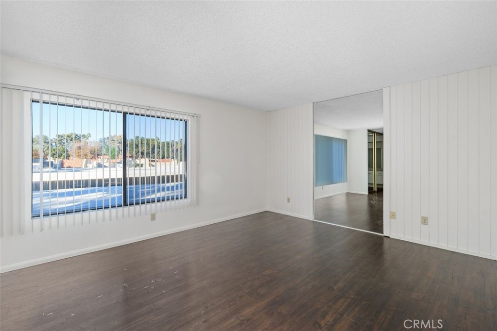 69707 Campana Court Rancho Mirage, CA 92270 - Photo 27 of 47 an empty room with wooden floor and windows