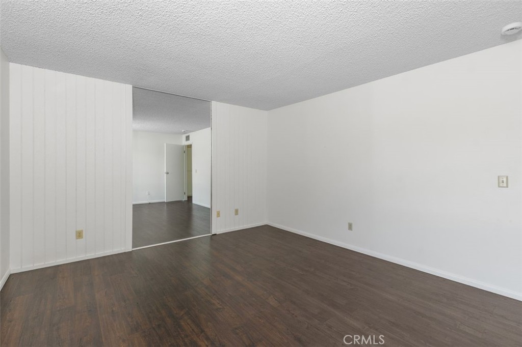 69707 Campana Court Rancho Mirage, CA 92270 - Photo 28 of 47 an empty room with wooden floor and white walls