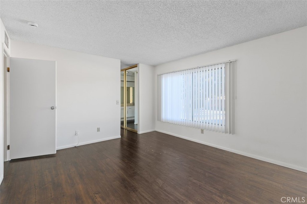69707 Campana Court Rancho Mirage, CA 92270 - Photo 29 of 47 an empty room with wooden floor and windows