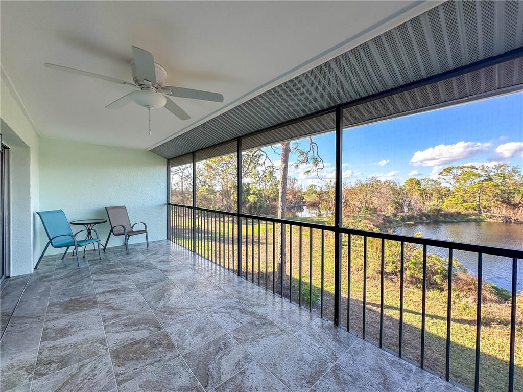 6800 Placida Road, Unit 268 Englewood, FL 34224 - Photo 21 of 33 a view of a porch with furniture and a floor to ceiling window