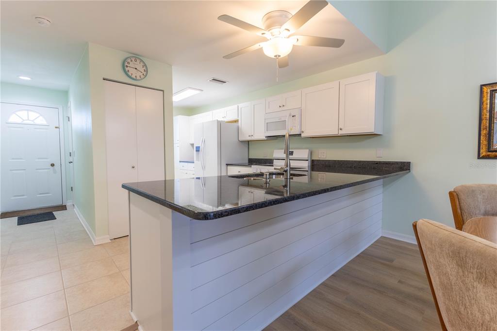 6800 Placida Road, Unit 268 Englewood, FL 34224 - Photo 10 of 33 a kitchen with stainless steel appliances granite countertop a sink a stove and a refrigerator