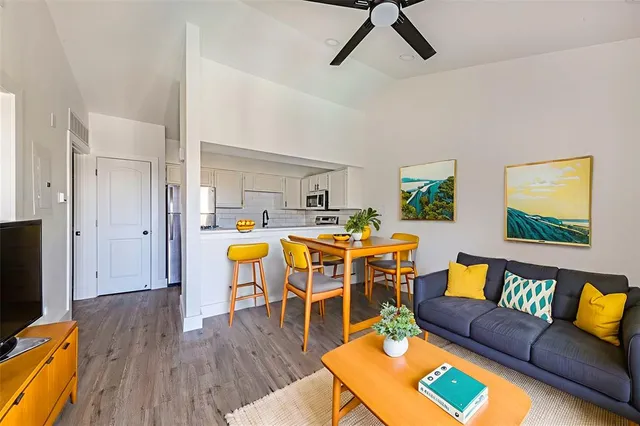 a living room with furniture and wooden floor
