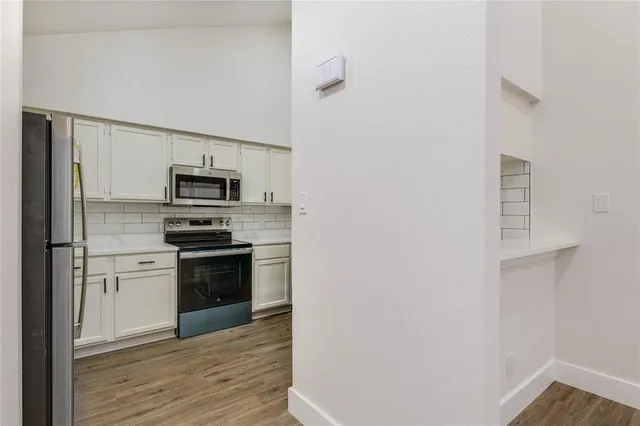 a kitchen with stainless steel appliances a refrigerator stove and microwave