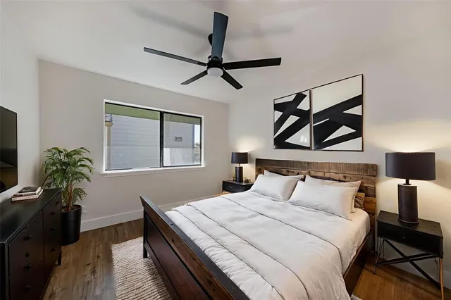 a bedroom with a bed and a painting on the wall