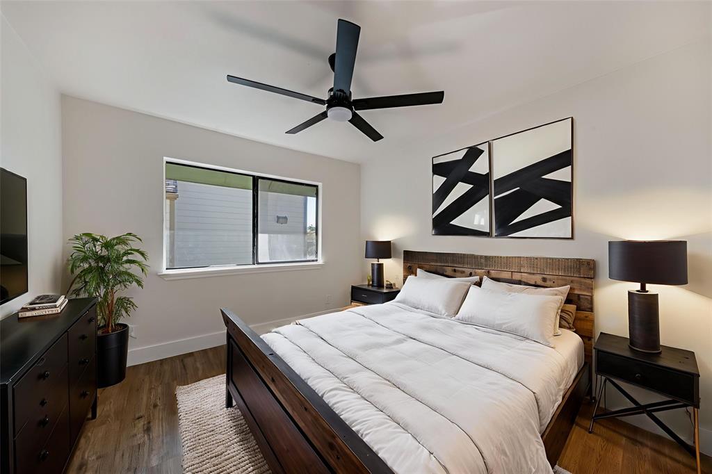 6108 Abrams Road, Unit 126 Dallas, TX 75231 - Photo 8 of 11 a bedroom with a bed and a painting on the wall