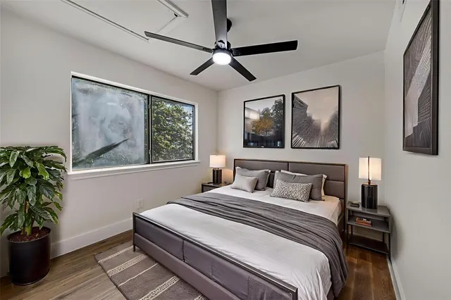 a bedroom with a bed and a potted plant