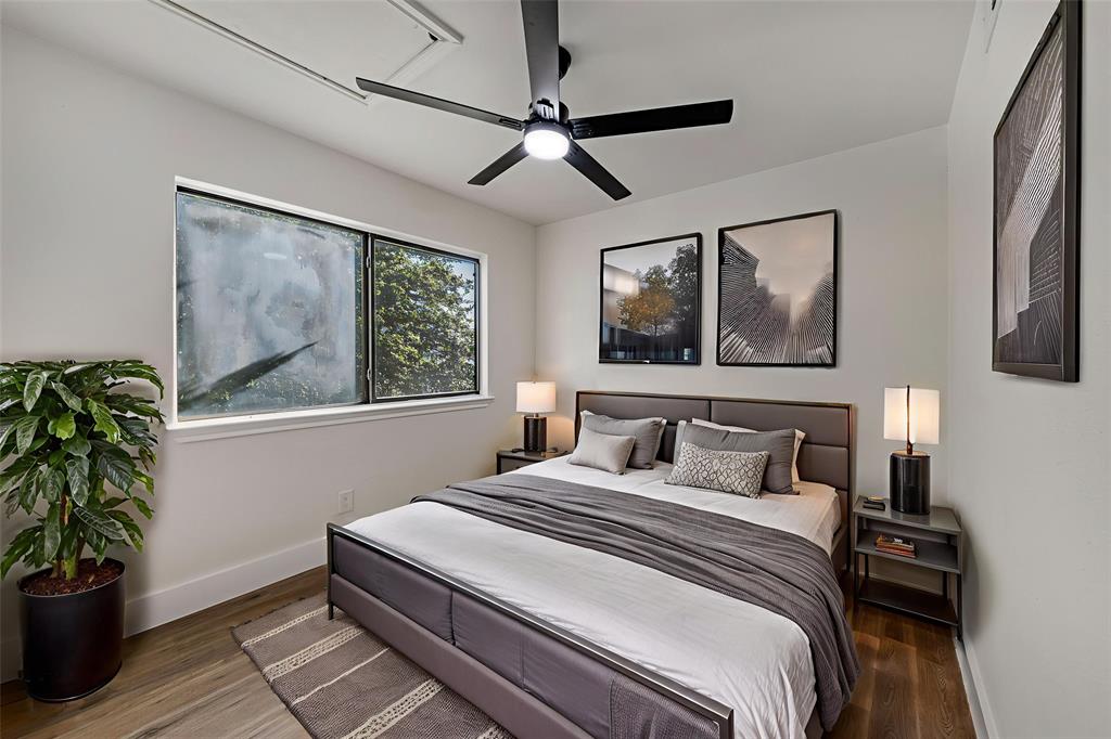 6108 Abrams Road, Unit 126 Dallas, TX 75231 - Photo 9 of 11 a bedroom with a bed and a potted plant