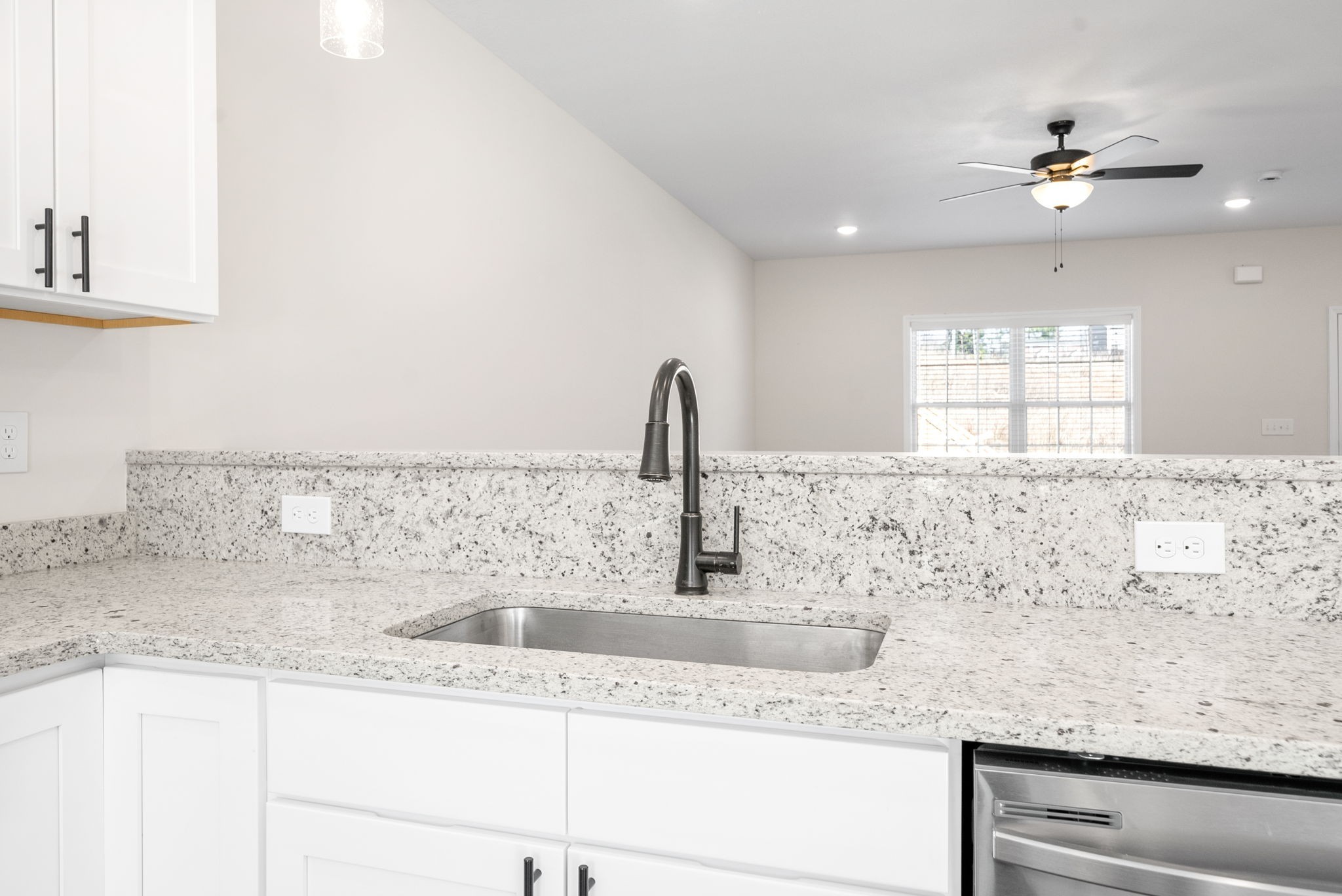 500 Peachers Mill Road, Unit C1 Clarksville, TN 37042 - Photo 7 of 31 a kitchen with granite countertop a sink and a white wooden cabinets