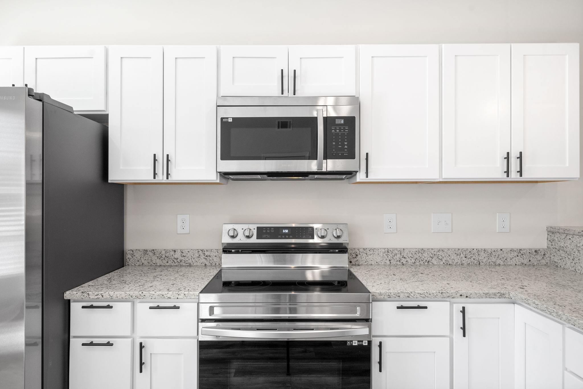 500 Peachers Mill Road, Unit C1 Clarksville, TN 37042 - Photo 8 of 31 a kitchen with stainless steel appliances granite countertop white cabinets and a stove a oven with white countertops