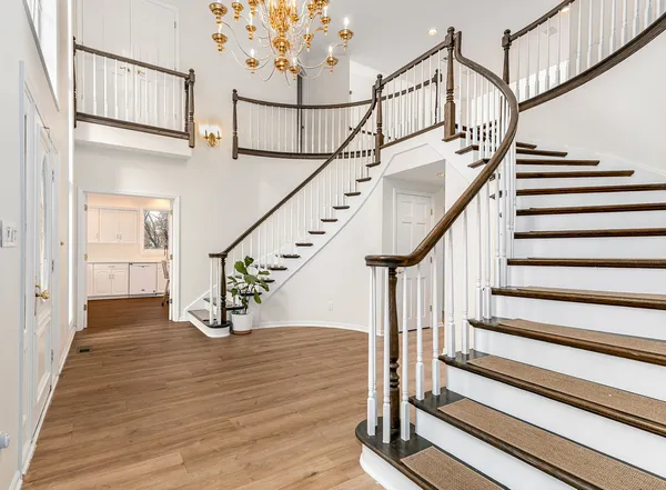 a view of entryway with wooden floor and a front door