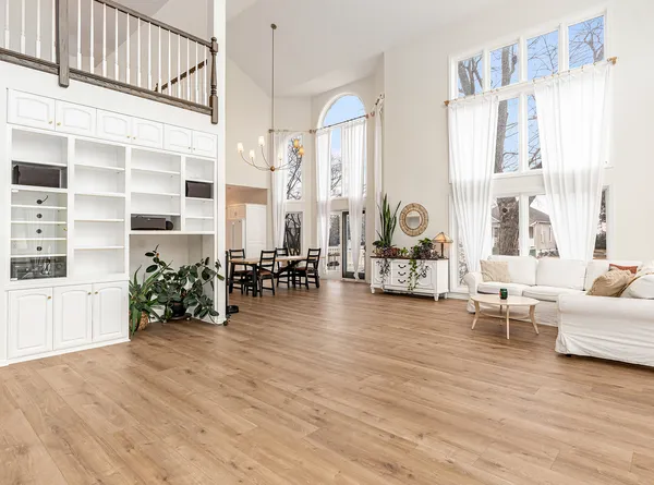 a living room with furniture and wooden floor