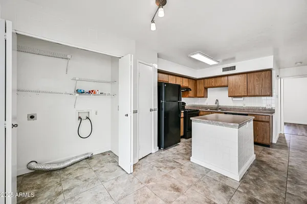 a kitchen with a refrigerator and a sink