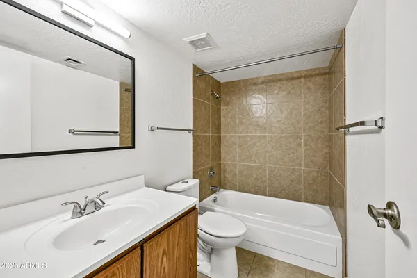 a bathroom with a sink mirror toilet and bathtub