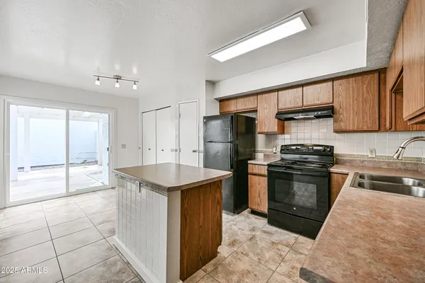a kitchen with refrigerator cabinets and a counter top space
