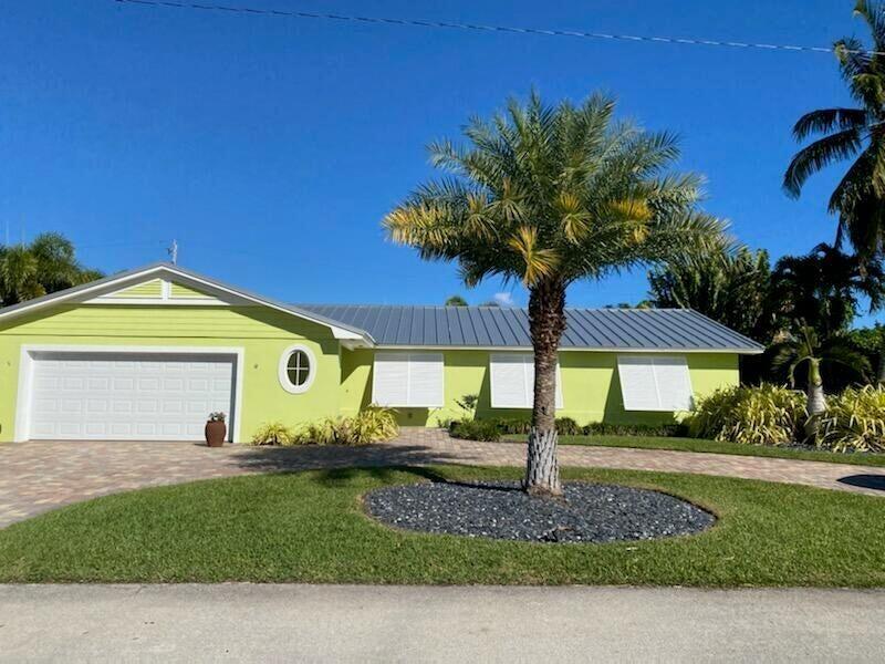 1150 Emerald Lane Singer Island, FL 33404 - Photo 3 of 25 a front view of a house with garden