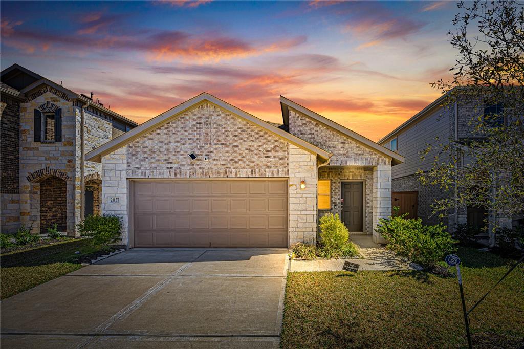21127 Dolphin Bay Lane Cypress, TX 77433 - Photo 1 of 21 a front view of a house with a yard and garage