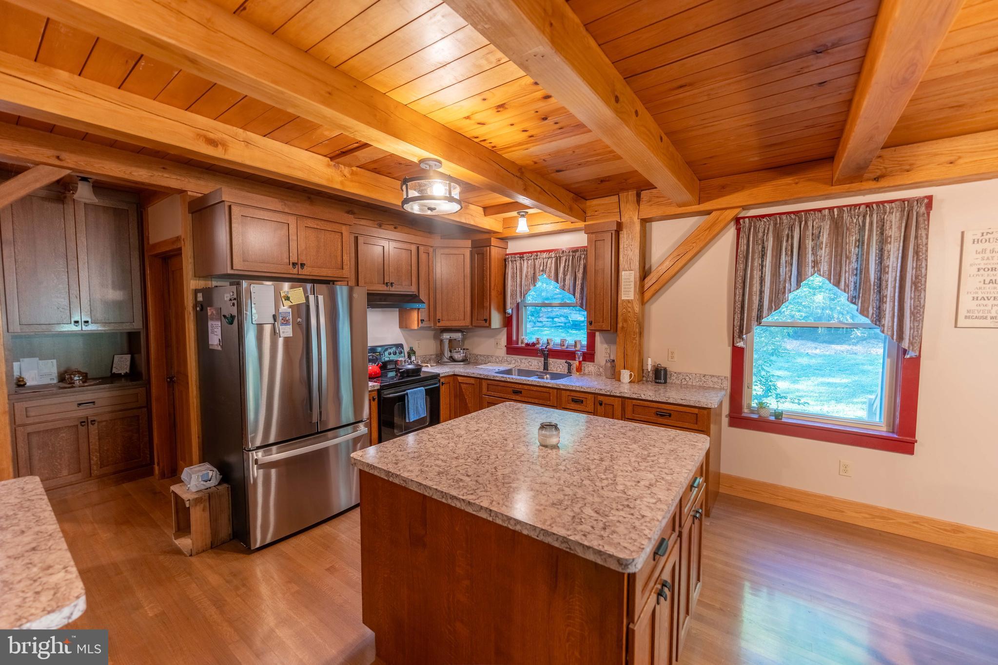 3171 Ritner Highway Newville, PA 17241 - Photo 11 of 63 a kitchen with stainless steel appliances granite countertop a refrigerator a sink a stove and a wooden floors